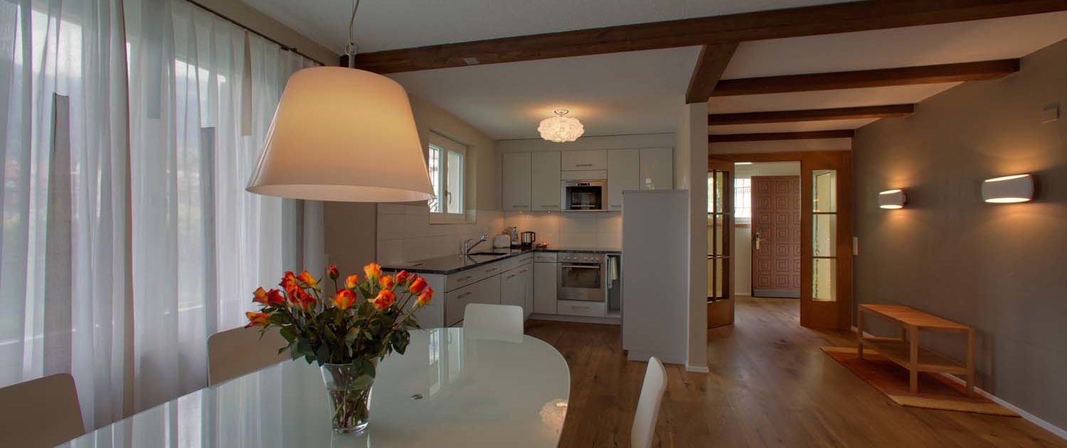 Dining area and kitchen in the Riverhouse holiday cottage of Hotel Bellevue Interlaken Switzerland