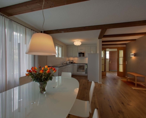 Dining area and kitchen in the Riverhouse holiday cottage of Hotel Bellevue Interlaken Switzerland