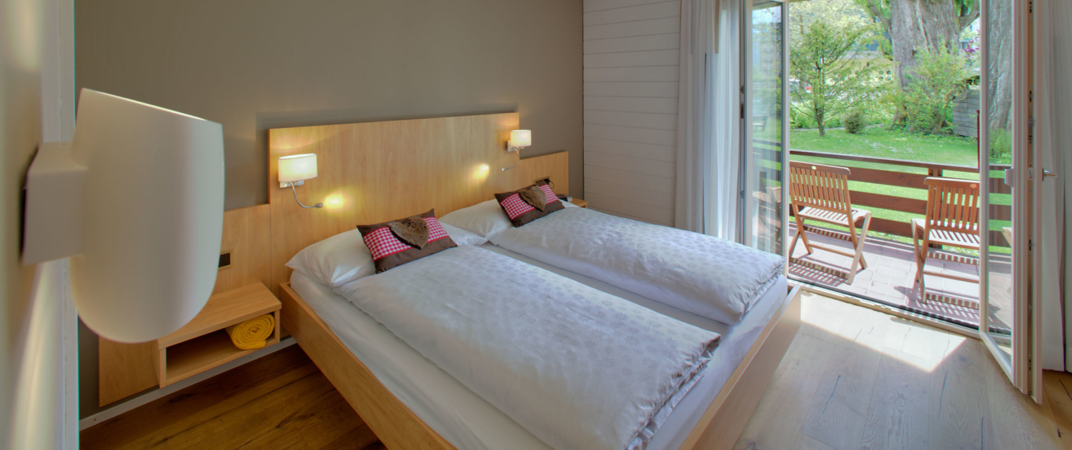 Bedroom with garden view in the holiday cottage of Hotel Bellevue Interlaken Switzerland